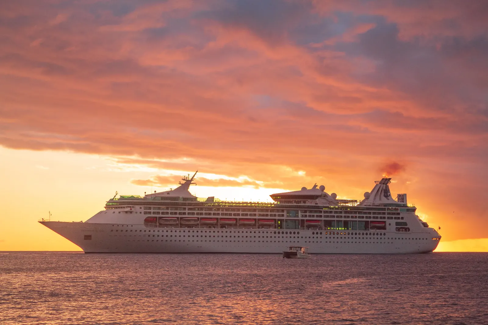 Cruise ship sailing at sunset